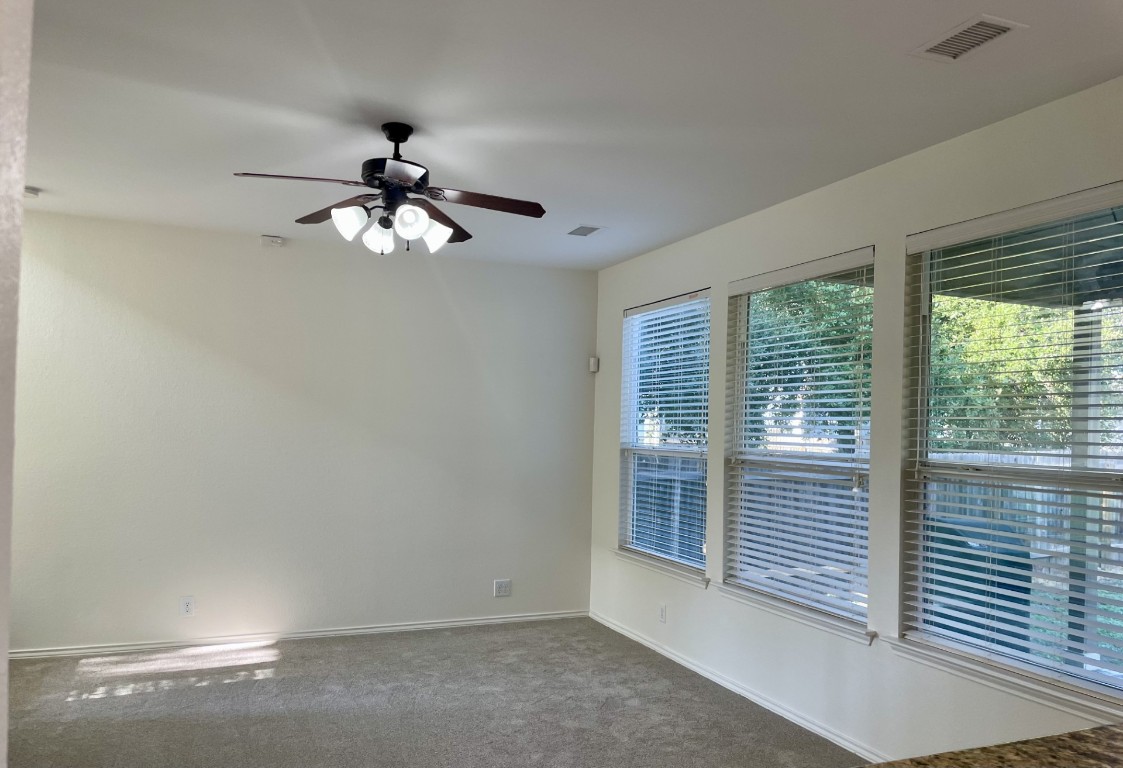 8725 White Ibis Drive Austin, TX 78729 - Photo 5 of 29 a view of a livingroom with a chandelier fan