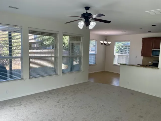 a view of an empty room with a fireplace and a window