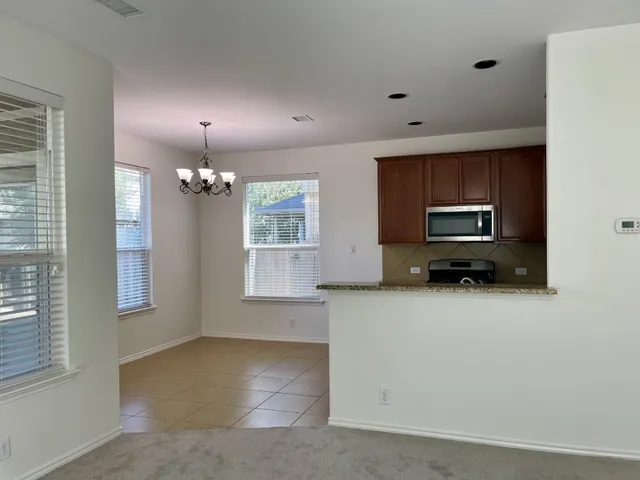 a view of a kitchen with a sink a dishwasher and cabinets