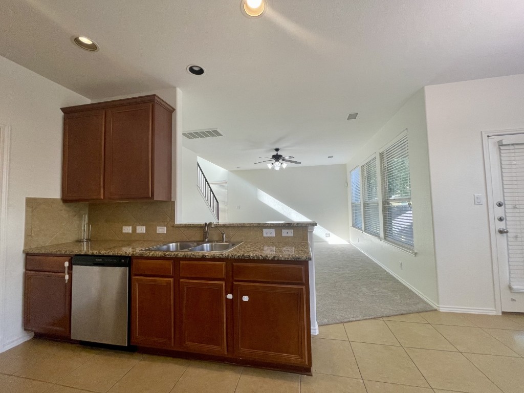 8725 White Ibis Drive Austin, TX 78729 - Photo 9 of 29 a kitchen with granite countertop a sink and cabinets