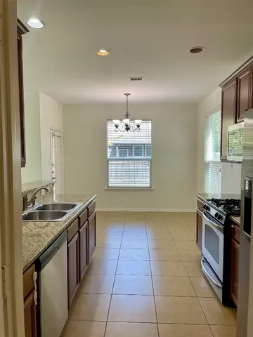 a kitchen with a stove sink and cabinets