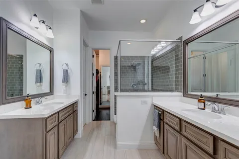 a spacious bathroom with a sink double vanity and a large mirror