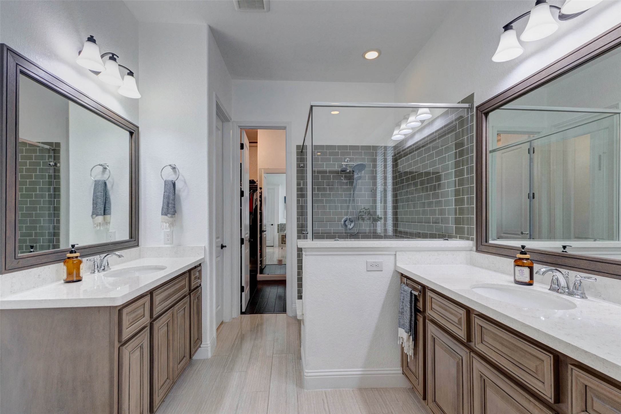 29903 Spring Side Court Fulshear, TX 77406 - Photo 25 of 50 a bathroom with a sink double vanity and a tub