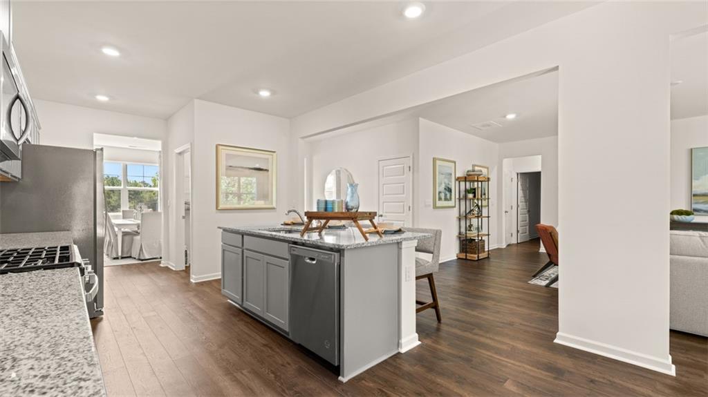 56 Weymouth Drive Locust Grove, GA 30248 - Photo 14 of 62 a kitchen with stainless steel appliances granite countertop a stove and a refrigerator