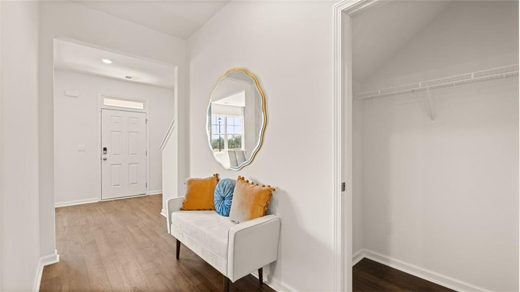 56 Weymouth Drive Locust Grove, GA 30248 - Photo 23 of 62 a living room with furniture and a mirror