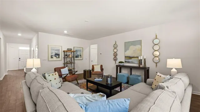 a spacious bedroom with furniture and a large window