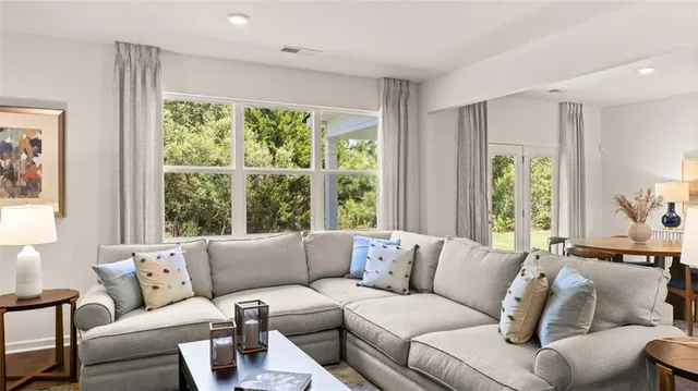 a living room with furniture and a large window