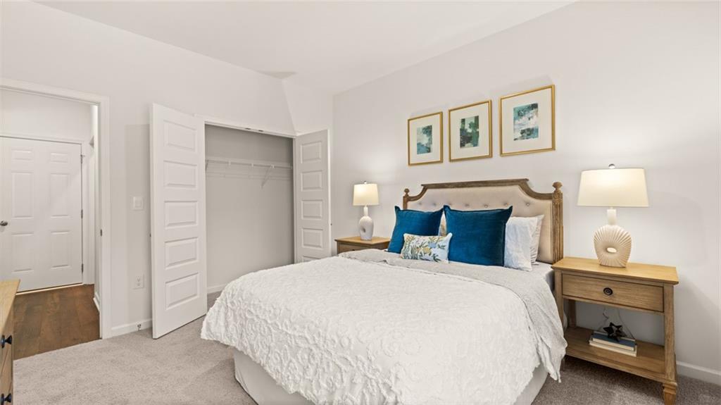 56 Weymouth Drive Locust Grove, GA 30248 - Photo 33 of 62 a bedroom with a bed and a lamp