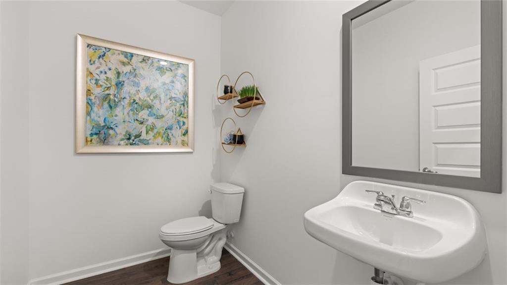 56 Weymouth Drive Locust Grove, GA 30248 - Photo 34 of 62 a bathroom with a toilet a sink and mirror