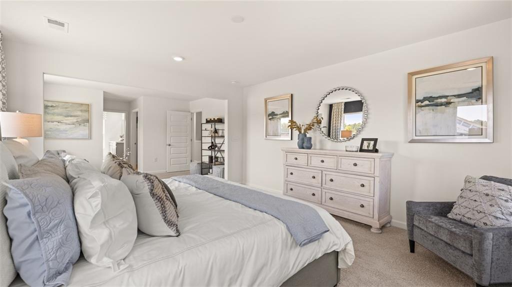 56 Weymouth Drive Locust Grove, GA 30248 - Photo 38 of 62 a bedroom with a bed and furniture