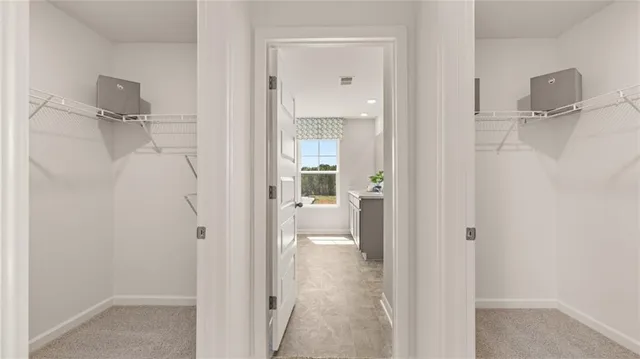 a bedroom with a bed and painting on the wall