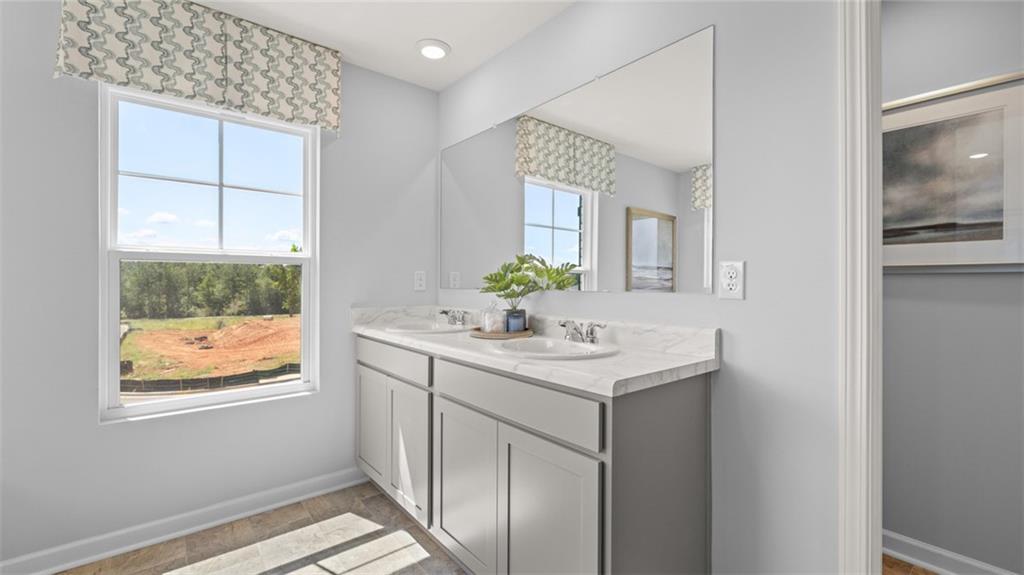 56 Weymouth Drive Locust Grove, GA 30248 - Photo 43 of 62 a bathroom with a sink and a mirror