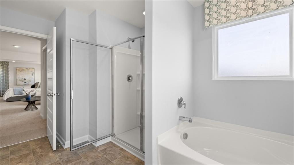 56 Weymouth Drive Locust Grove, GA 30248 - Photo 46 of 62 a bathroom with a bathtub and a shower