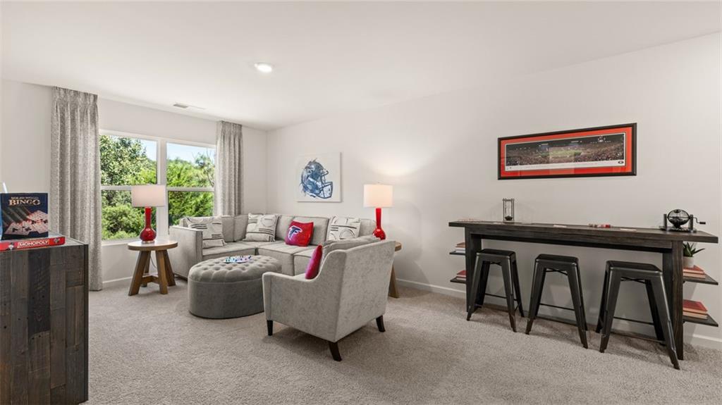 56 Weymouth Drive Locust Grove, GA 30248 - Photo 48 of 62 a living room with furniture and a large window