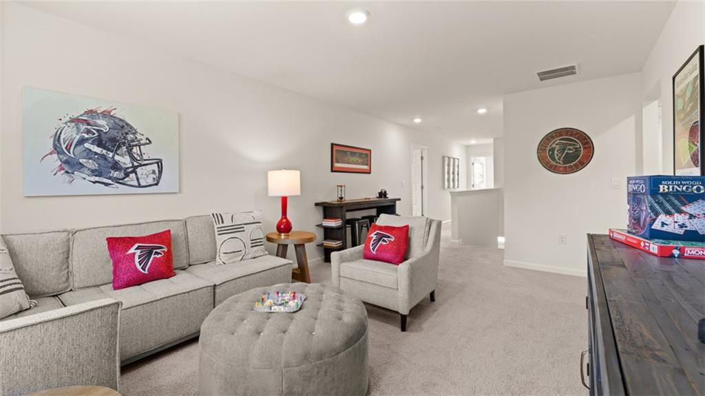 56 Weymouth Drive Locust Grove, GA 30248 - Photo 50 of 62 a living room with furniture and a couch