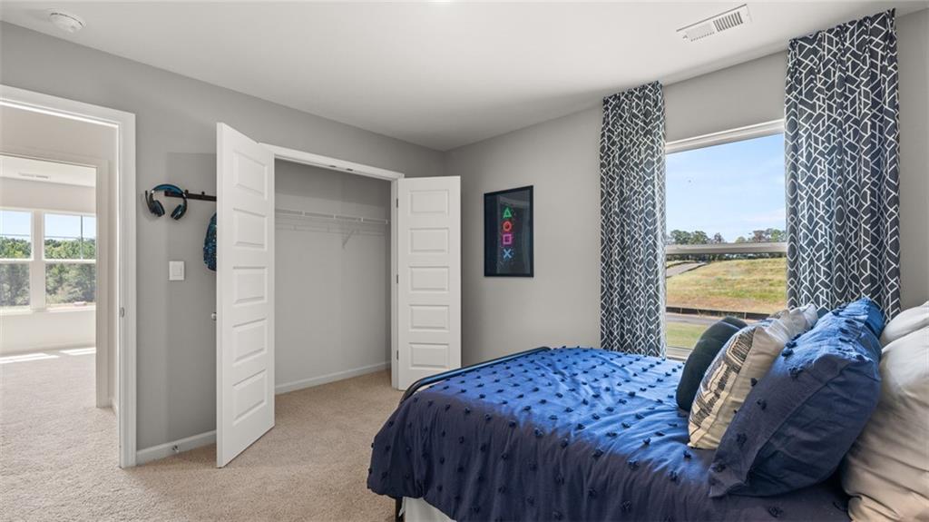 56 Weymouth Drive Locust Grove, GA 30248 - Photo 58 of 62 a bedroom with a bed and a window