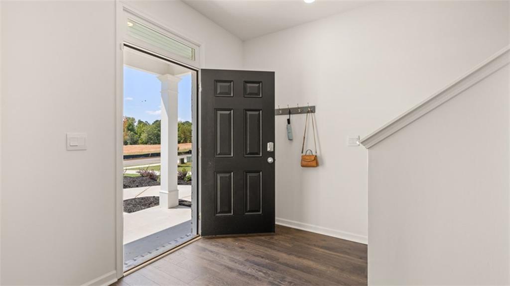 56 Weymouth Drive Locust Grove, GA 30248 - Photo 6 of 62 a view of a hallway with wooden floor and entryway