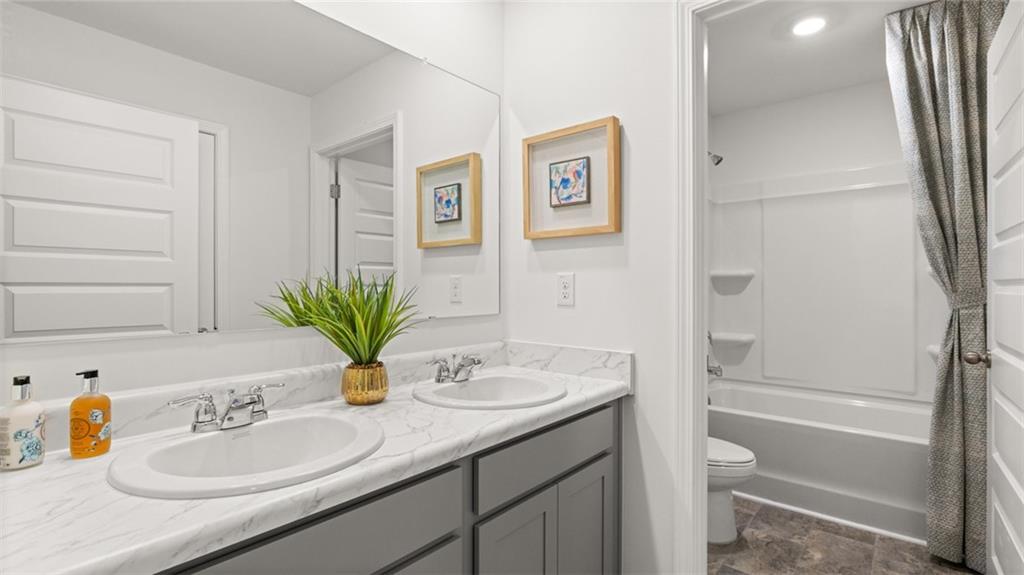 56 Weymouth Drive Locust Grove, GA 30248 - Photo 61 of 62 a bathroom with a sink double vanity granite tub and shower