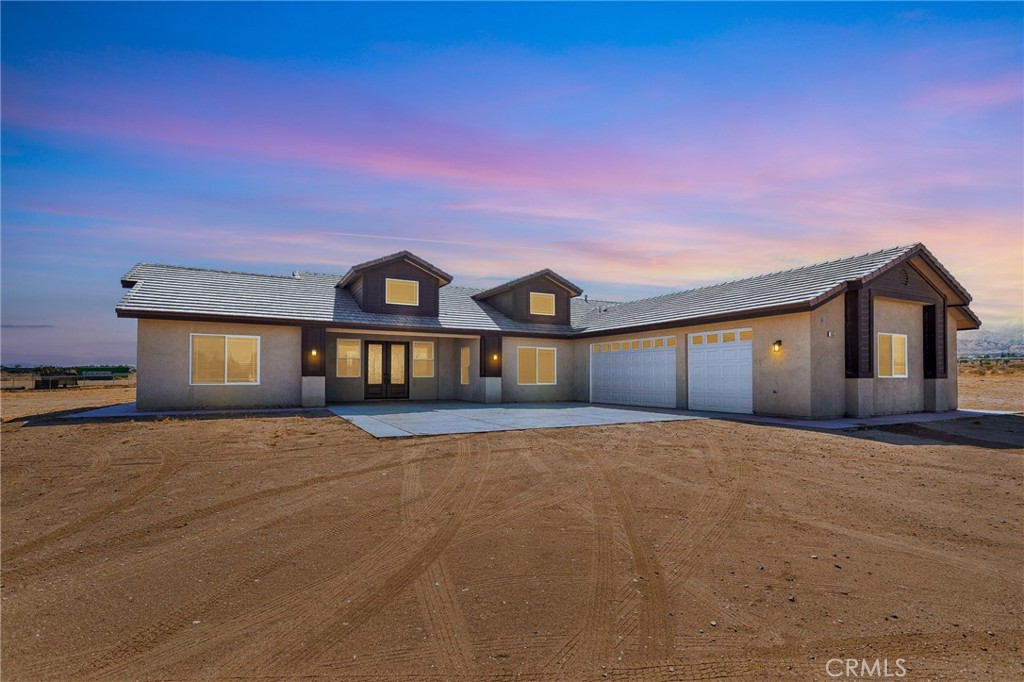 10055 Eaby Road Phelan, CA 92371 - Photo 3 of 19 a front view of a house with a yard and garage
