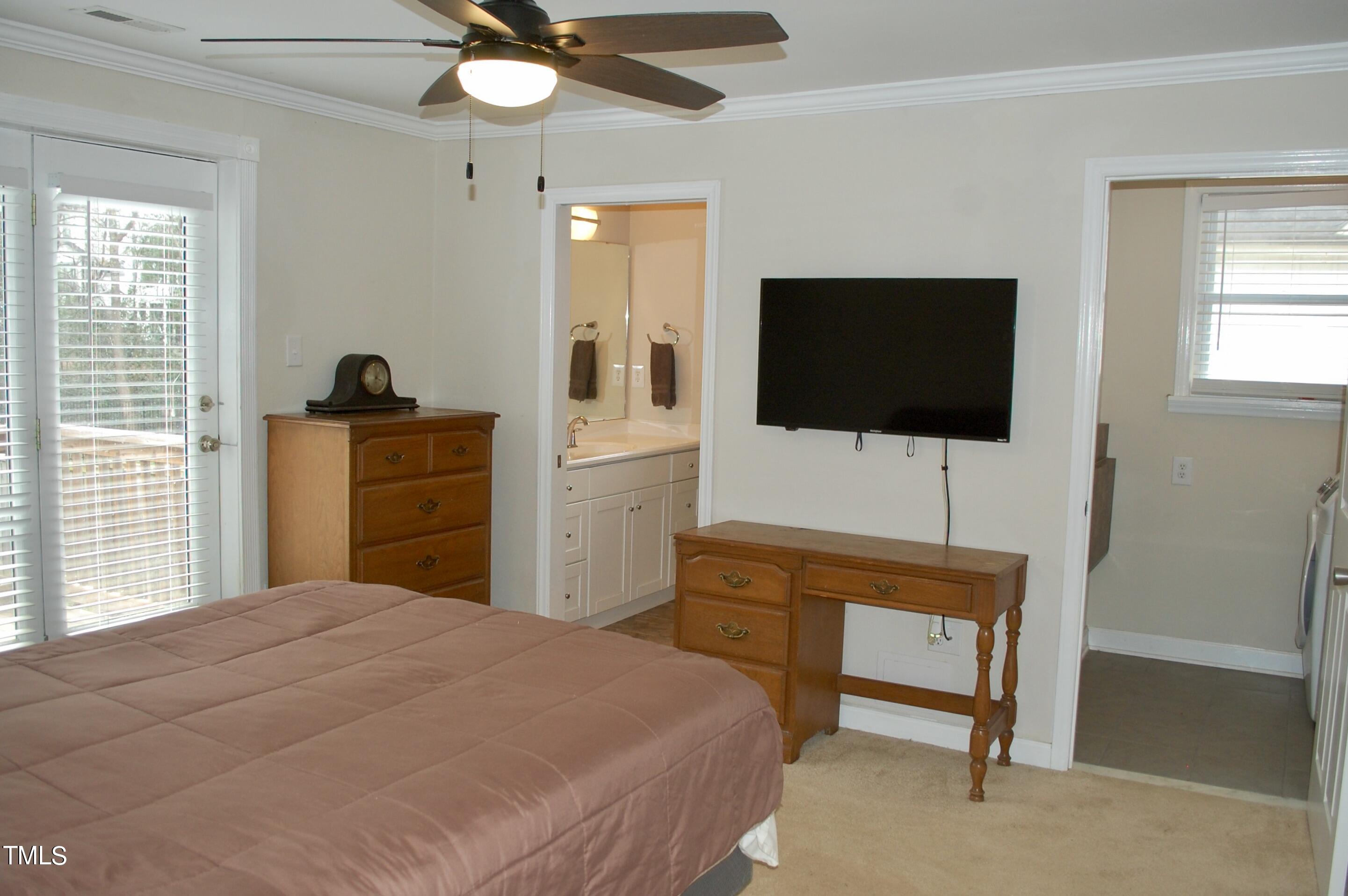 933 Brookside Drive Raleigh, NC 27604 - Photo 17 of 38 a bedroom with a bed and a flat screen tv