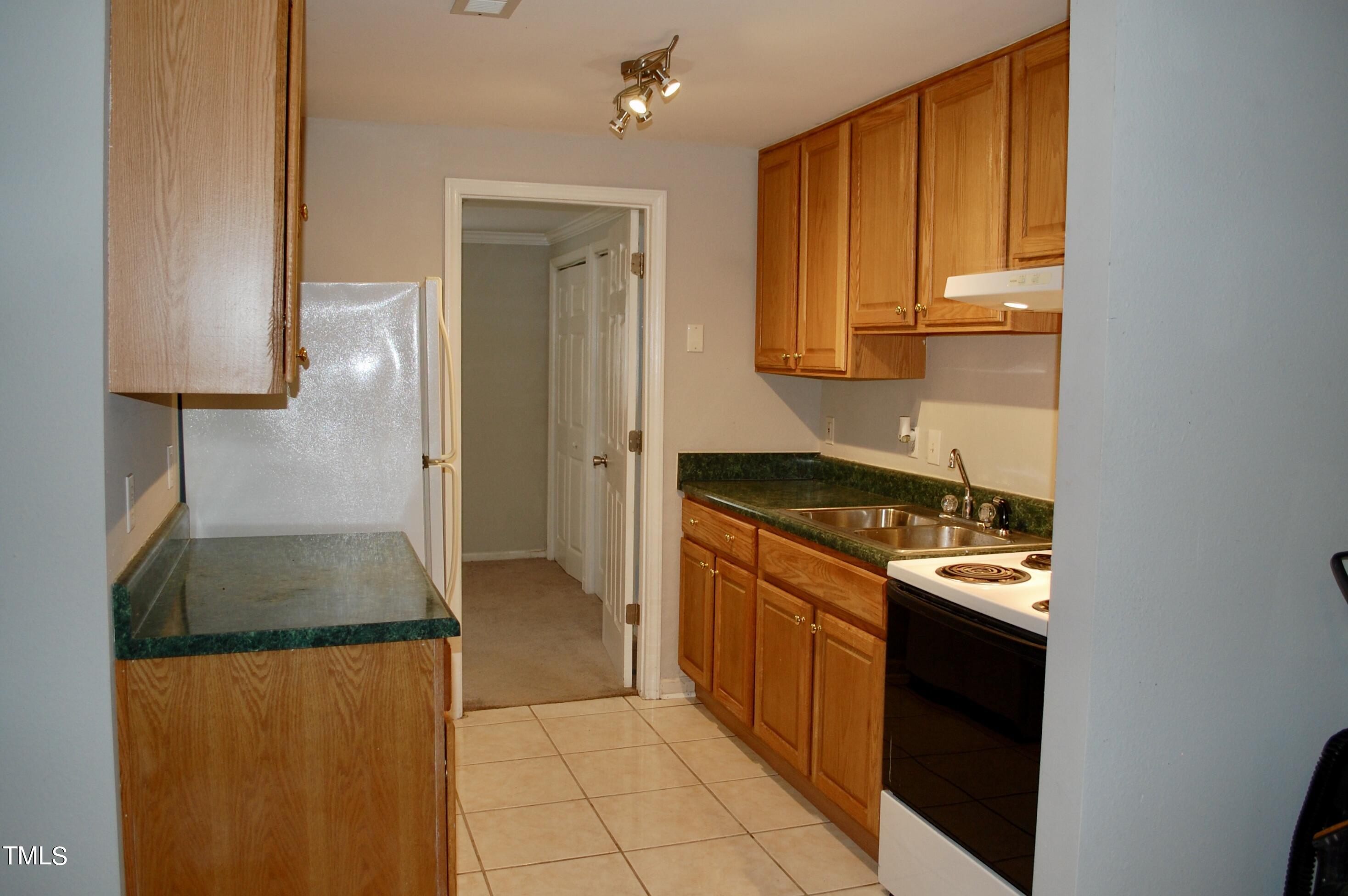 933 Brookside Drive Raleigh, NC 27604 - Photo 27 of 38 a kitchen with stainless steel appliances granite countertop a refrigerator and a stove