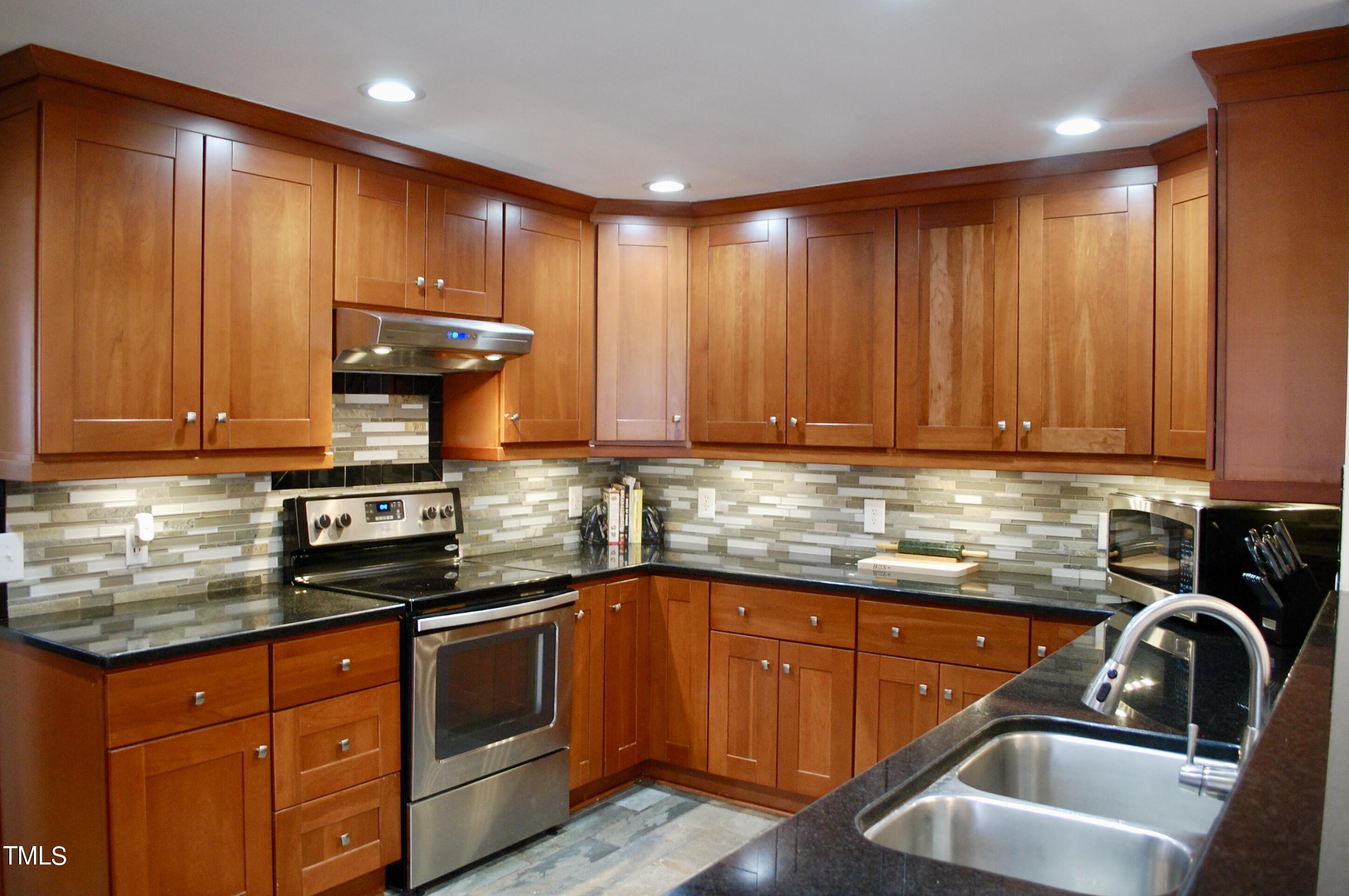 933 Brookside Drive Raleigh, NC 27604 - Photo 3 of 38 a kitchen with a sink and cabinets