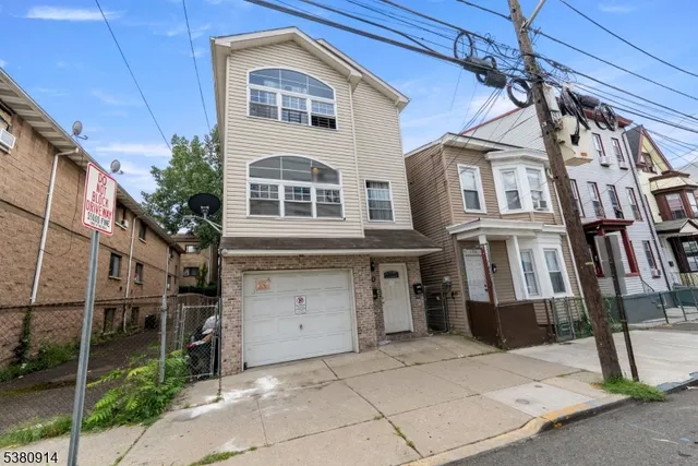a view of a brick house with many windows