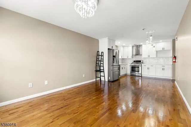 a view of a kitchen with a sink and a refrigerator