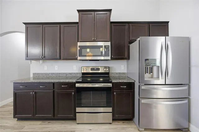 a kitchen with a refrigerator stove and microwave