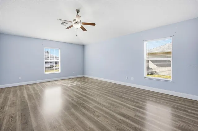 wooden floor in an empty room with a window