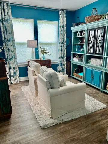 a living room with furniture and a book shelf