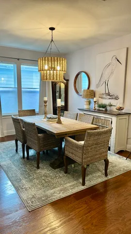 a living room with a table chairs and a wooden floor