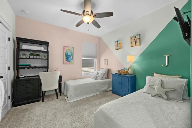 a bedroom with furniture and a large window