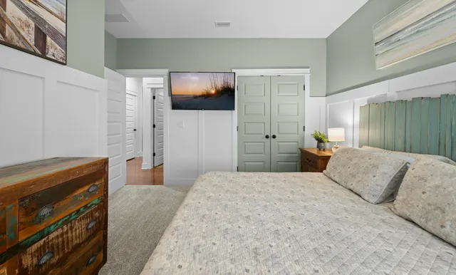 a bedroom with a bed and a flat screen tv