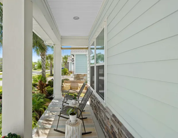 a balcony with furniture and a potted plant