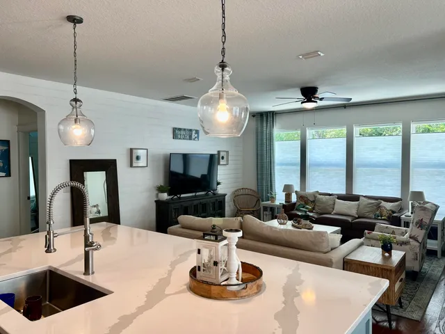 a living room with stainless steel appliances kitchen island granite countertop furniture and a view of kitchen