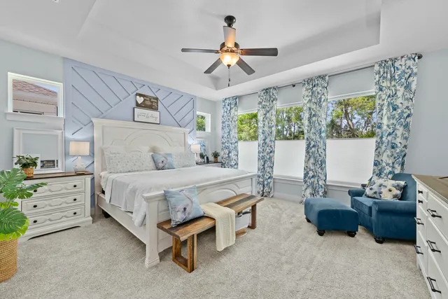 a spacious bedroom with a bed and a dresser