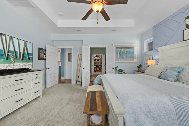 a bedroom with furniture and a flat screen tv