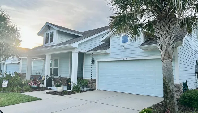 a front view of a house with garden