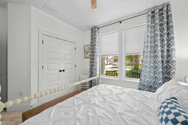 a bedroom with a large bed and a window