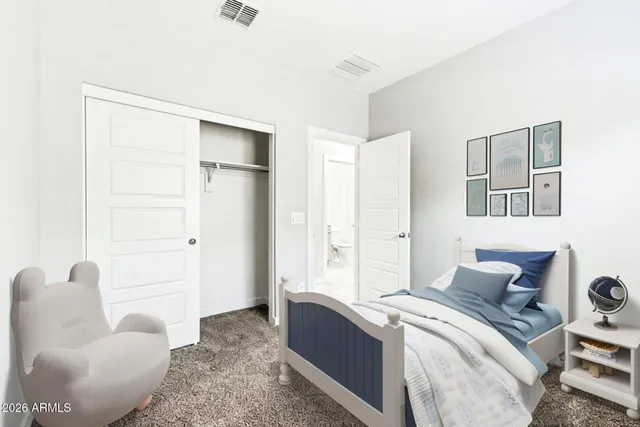 a bedroom with a bed and a couch