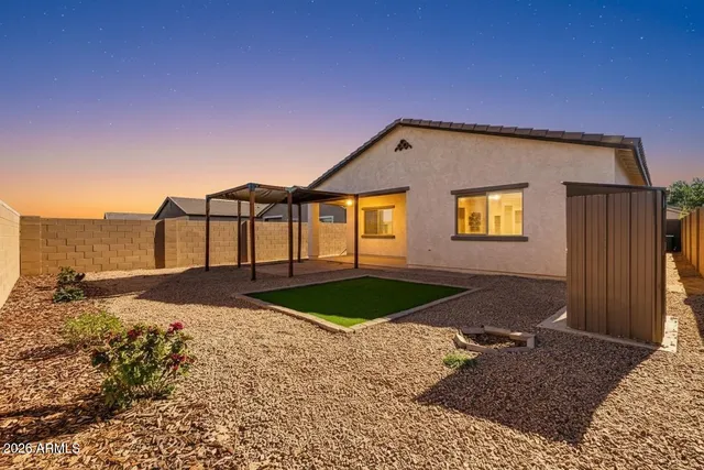 a view of a house with a backyard