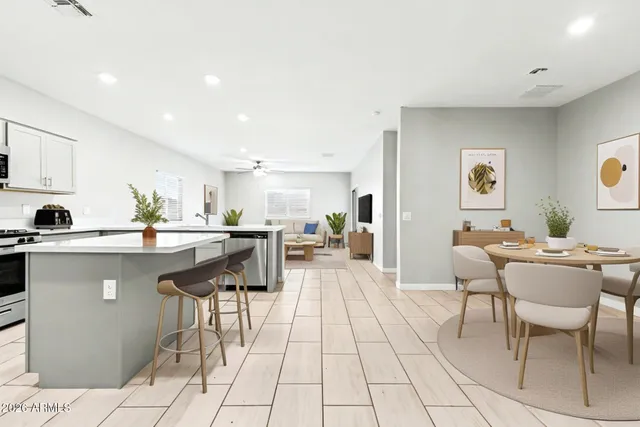 a kitchen with stainless steel appliances kitchen island granite countertop a sink and cabinets