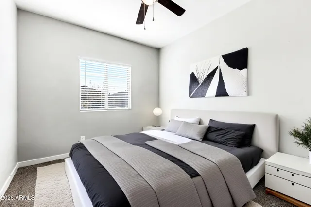 a bedroom with a bed and a painting on the wall