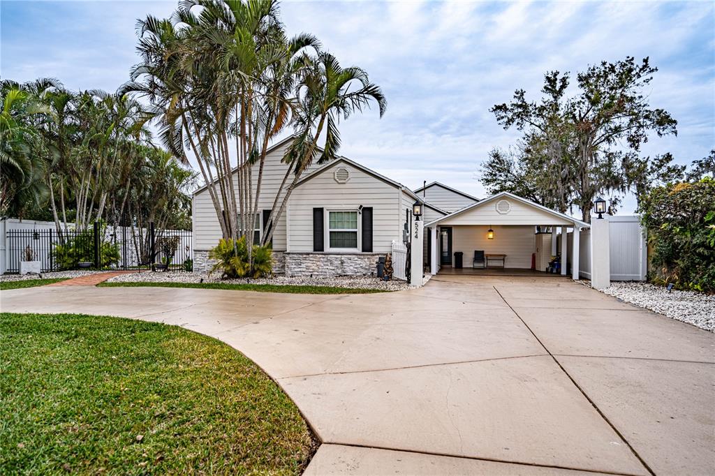 524 Arneson Avenue Auburndale, FL 33823 - Photo 1 of 1 a front view of a house with a garden