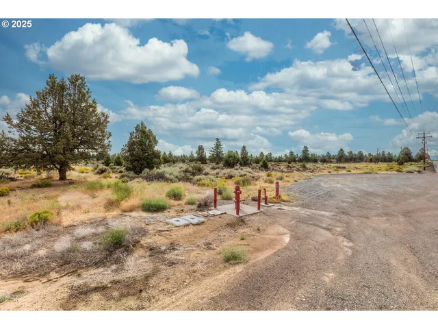 a view of a lake with beach and city in the back