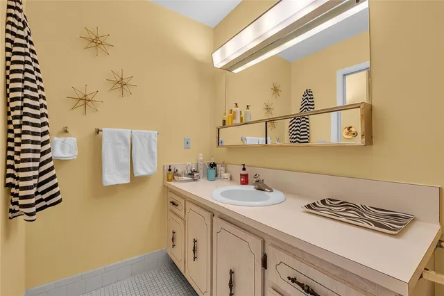 a bathroom with a sink and a mirror