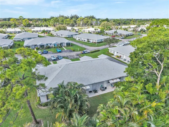 an aerial view of residential houses with outdoor space and swimming pool