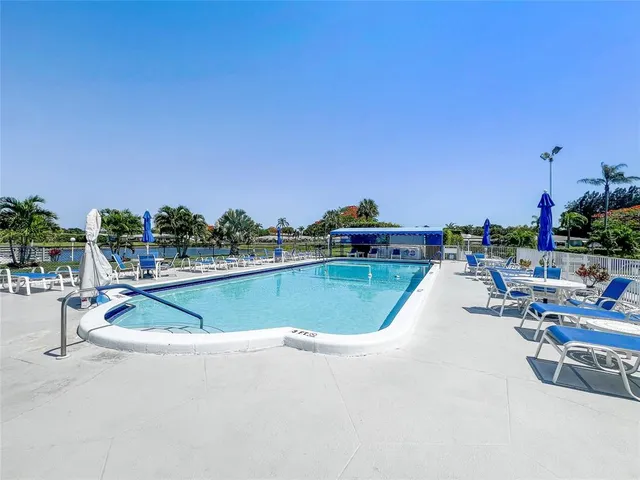 a view of a swimming pool and lounge chairs