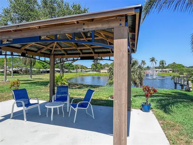 a view of a patio with a table chairs and a backyard